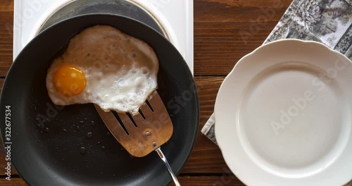 Top view food. Cooking With Mother. Beautiful Little Girl Learns How To Make Fried Egg.