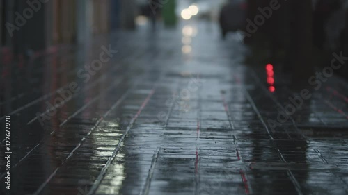 Wallpaper Mural Rain and puddle on sidewalk with following blurry view to the street with car traffic and man with umbrella. Dull raw evening Torontodigital.ca