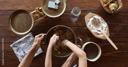 Top view preparing food. Cooking With Grandma. Beautiful Little Girl Learns How To Make Cookies.
