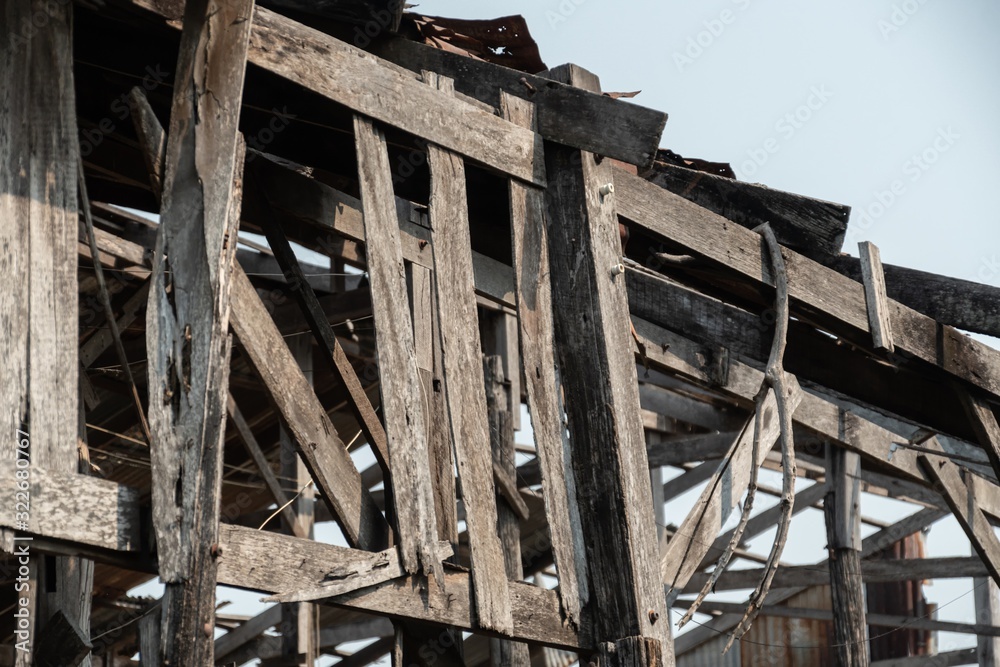 Ruins of an abandoned wooden house, rusty galvanized sheet roof