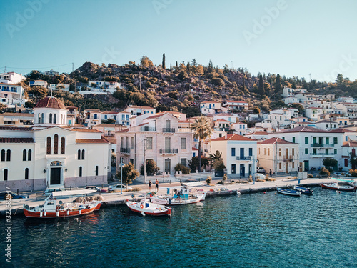 Scenic view of Poros island in a typical summer day. Old town with traditional white houses near the sea. Saronic gulf, Greece, Europe.
