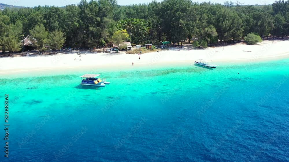 Paradise tropical island with green trees forest and white sand of exotic beach washed by blue azure lagoon where boats floating in Cambodia Paradise tropical island with green trees forest and white sand of exotic beach washed by blue azure lagoon where boats floating in Cambodia