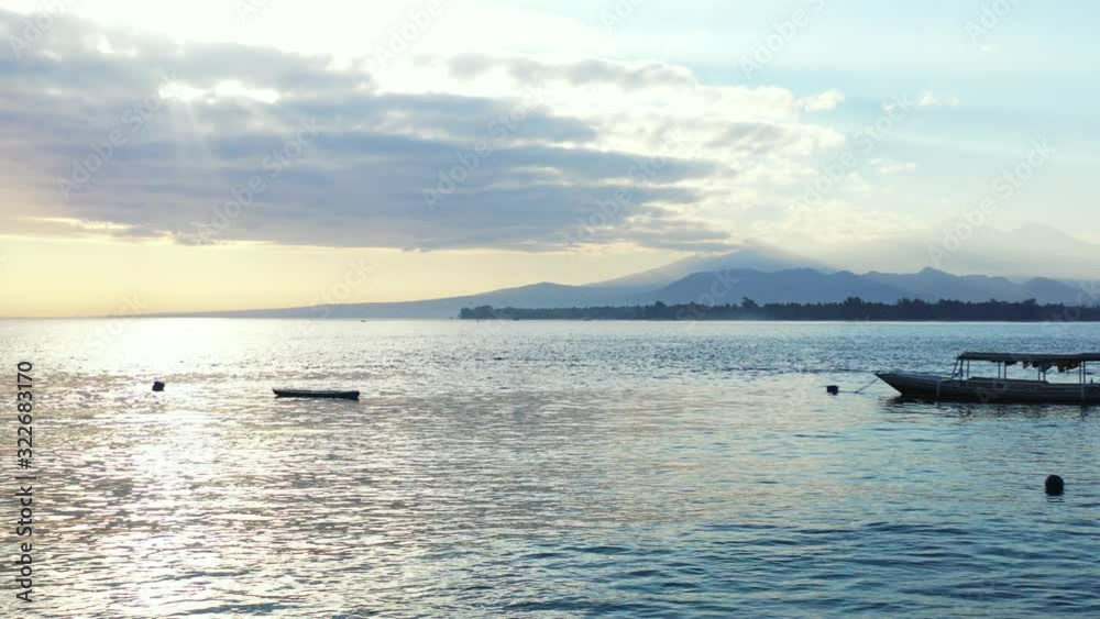 Beautiful scenery of rippling water reflecting the sunlight during the late afternoon with mountains in the distance Beautiful scenery of rippling water reflecting the sunlight during the late afternoon with mountains in the distance