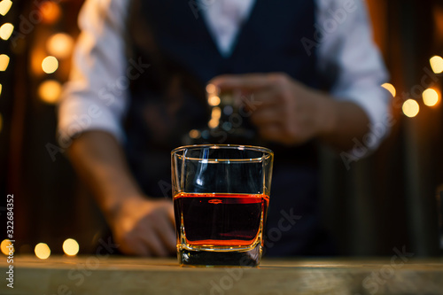 Bartender Serve Whiskey  on wood bar 