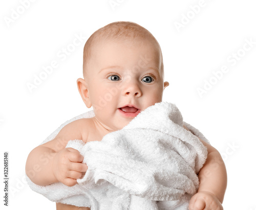 Portrait of cute little baby wrapped in towel on white background
