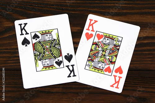 Playing cards for poker on a wooden table. 
