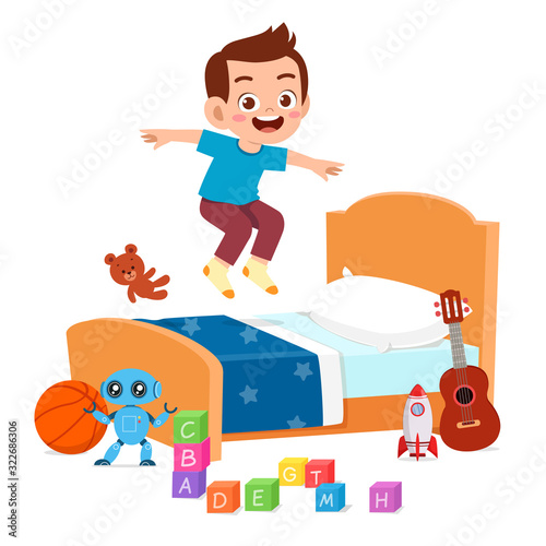 happy cute little kid boy jump on bed