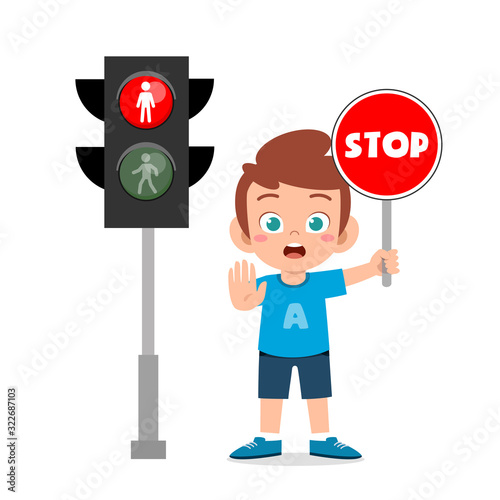 happy cute kid boy with traffic sign