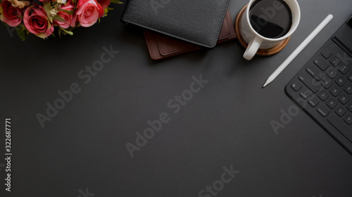 Top view of dark modern workplace with copy space on black table background