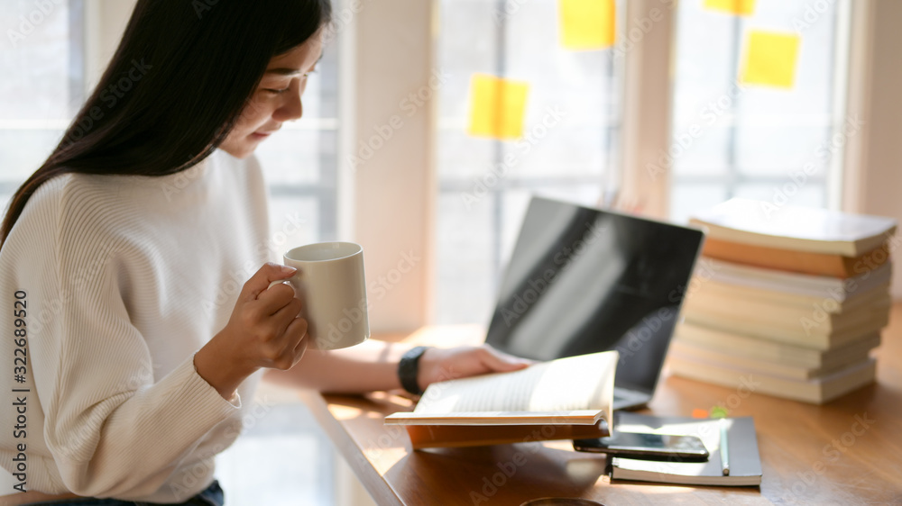 Portrait of college student studying for her midterm exam in comfortable workspace Portrait of college student studying for her midterm exam in comfortable workspace