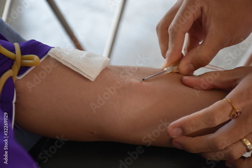 Doctor is using blood collection needle.