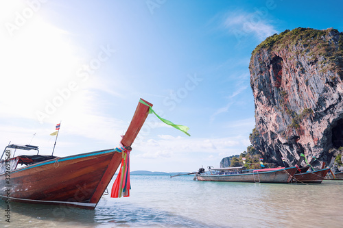 Fototapeta Naklejka Na Ścianę i Meble -  Traditional longtail boats, rocks, cliffs, tropical white sand beach. Traveling by Thailand.