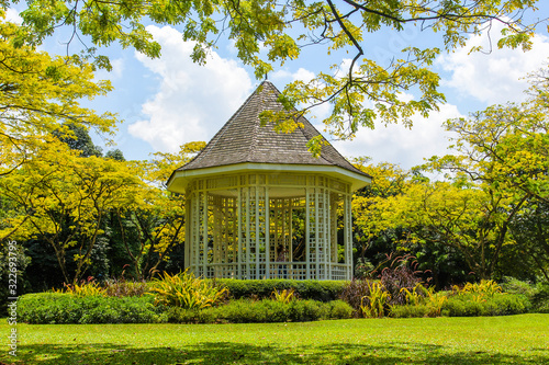Wooden house gazebo in the colorful tropical garden