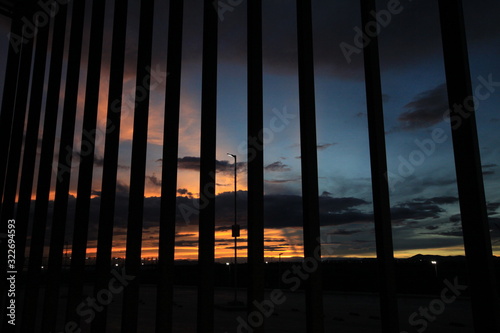 sunset and steel bars