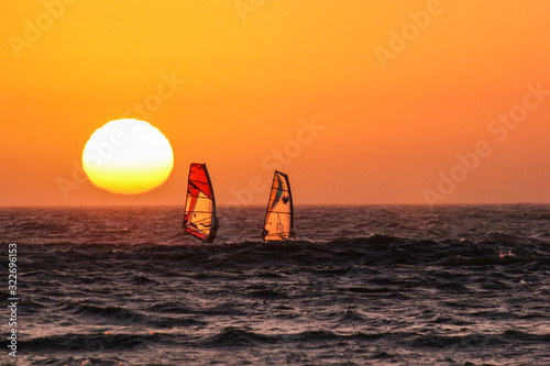 Unforgettable Windsurfing at sunset © nelasova