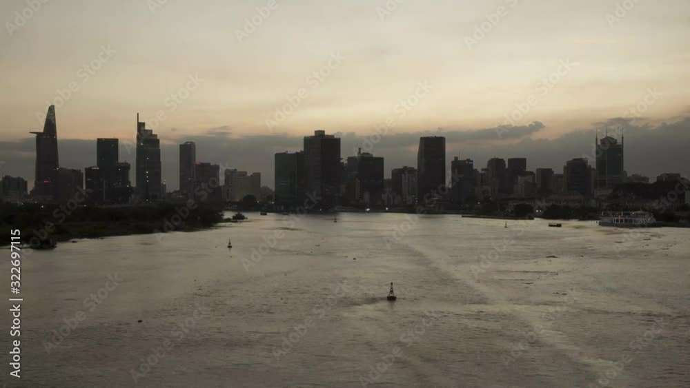 Saigon River day to night time lapse with Ho Chi Minh City Skyline at golden hour. Featured are river boats, dramatic sky of the Vietnamese financial capital Saigon River day to night time lapse with Ho Chi Minh City Skyline at golden hour. Featured are river boats, dramatic sky of the Vietnamese financial capital