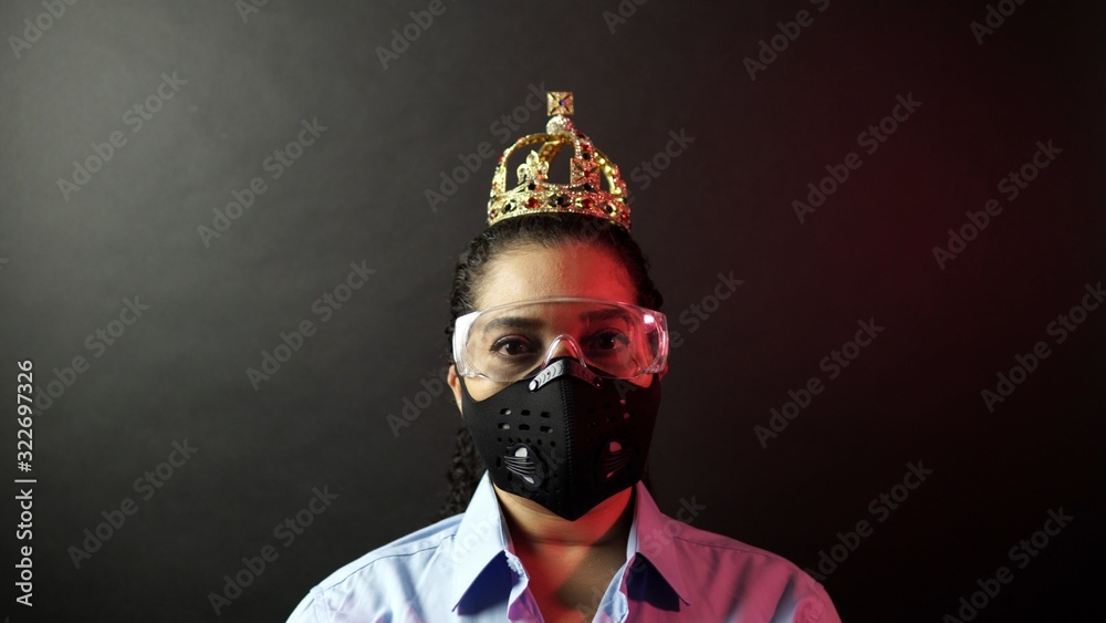 Woman in urban protective air mask with glasses, wearing crown or corona. Coronavirus pathogen outbreak pandemic concept. Virus disease 2019-nCoV or covid-19 protection and prevention. Woman in urban protective air mask with glasses, wearing crown or corona. Coronavirus pathogen outbreak pandemic concept. Virus disease 2019-nCoV or covid-19 protection and prevention.