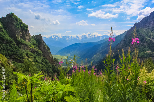 Beautiful landscape of the meadow on a background of snow-capped peaks of the Caucasus Mountains of Georgia