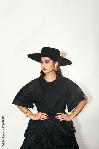 Woman in Gold Jewelry and Hat