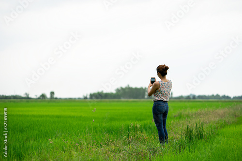 girl take the photo by mobile phone in the field