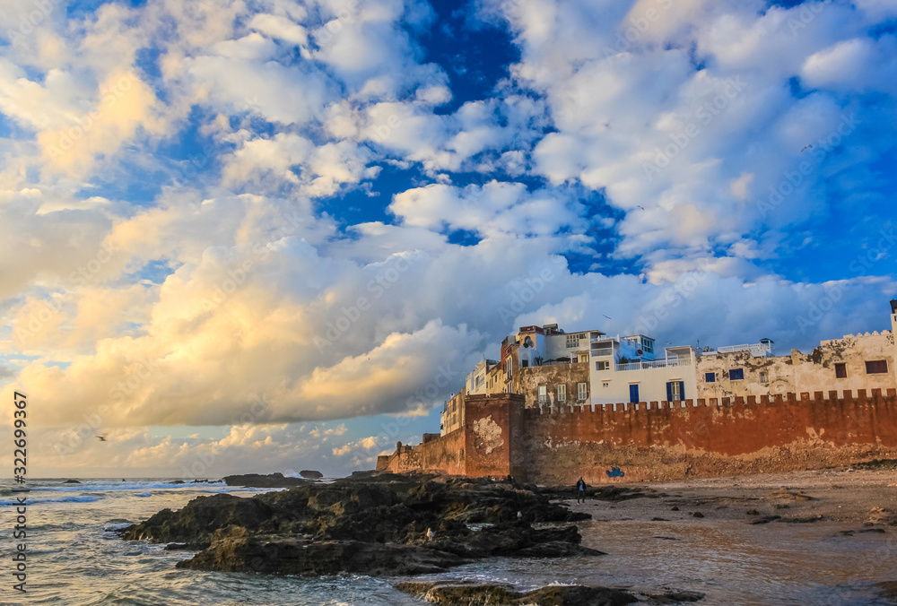 Ancient walls of the medina in Essaouira at sunset clouds