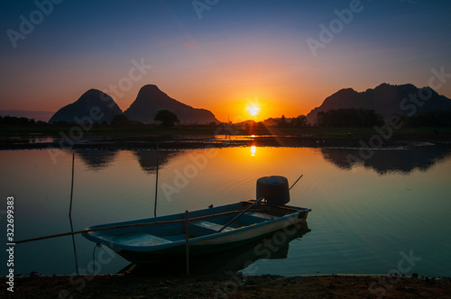 Sunrise on the lake with boat