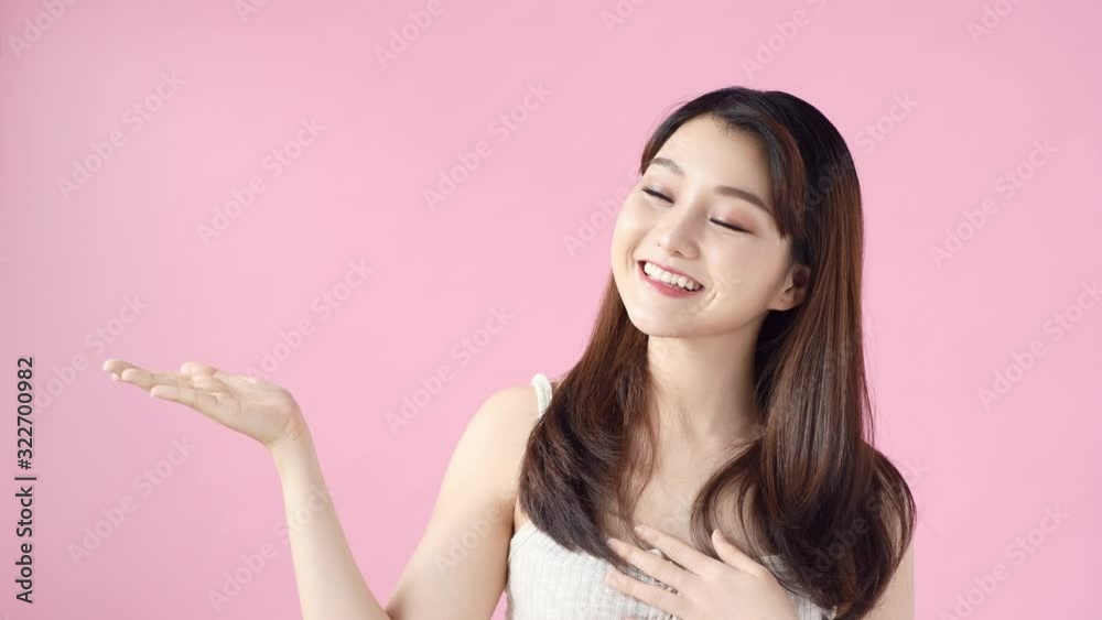 Casual woman presenting copy space on pink background. Portrait of pretty girl advertise product with hand gesture in studio. Casual woman presenting copy space on pink background. Portrait of pretty girl advertise product with hand gesture in studio.