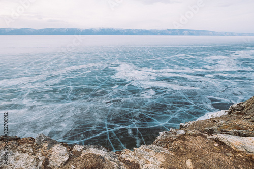 Russia. Lake Baikal. March. Panorama in blue tones ice-covered lake and mountains