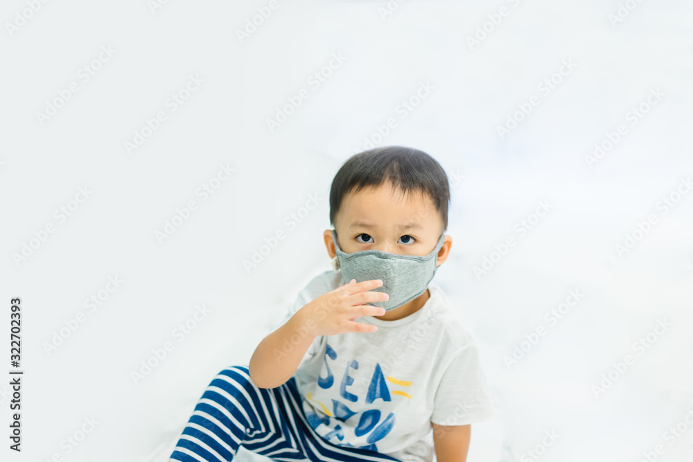 Coronavirus and Air pollution pm2.5 concept.Little chinese wuhan boy wearing mask for protect pm2.5 in Airport terminal.Toddler boy play in airport.Wuhan coronavirus and epidemic virus symptoms. Coronavirus and Air pollution pm2.5 concept.Little chinese wuhan boy wearing mask for protect pm2.5 in Airport terminal.Toddler boy play in airport.Wuhan coronavirus and epidemic virus symptoms.