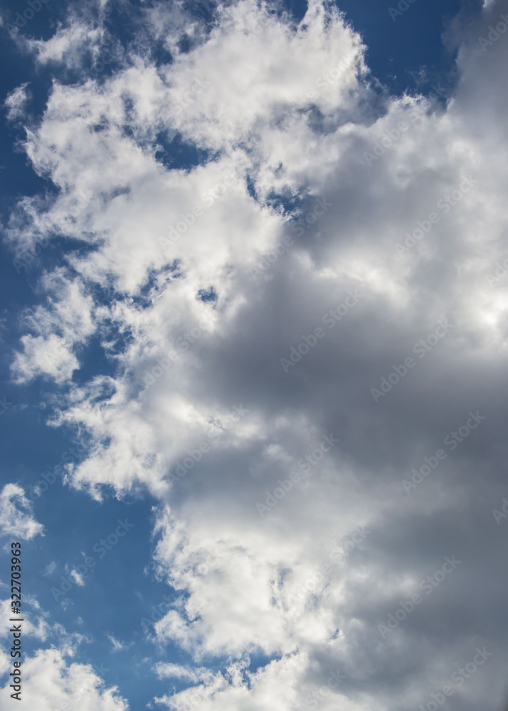 Beautiful white fluffy clouds against blue sky, natural background