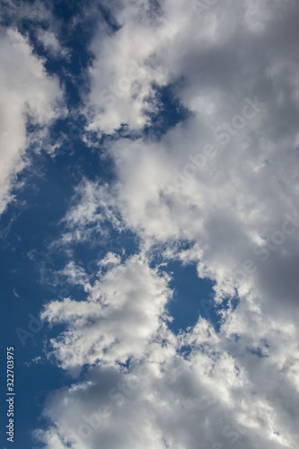 Beautiful white fluffy clouds against blue sky  natural background