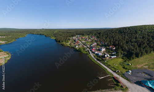 Aerial view of houses and pond in Pervouralsk city. Summer