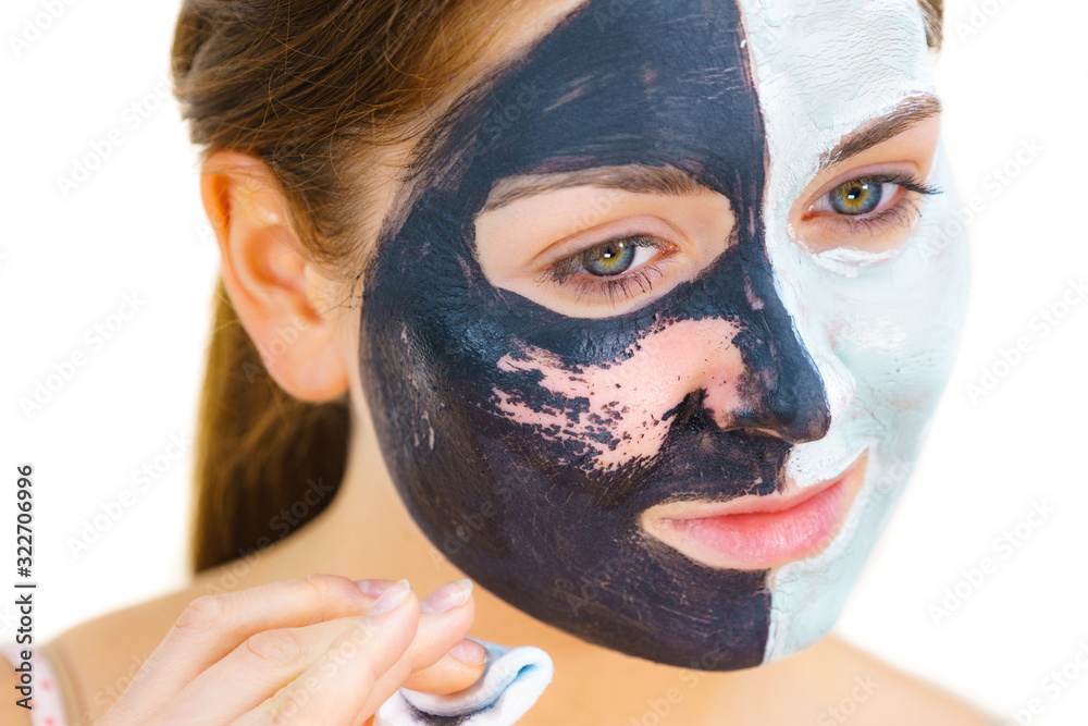 Girl remove black white mud mask from face Girl remove black white mud mask from face