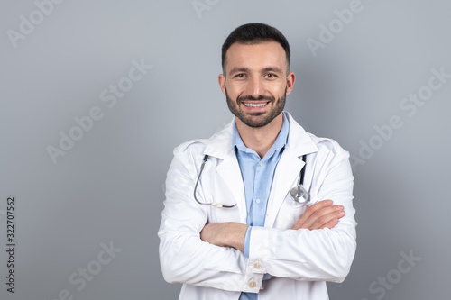 Doctor in a white robe smiling positively