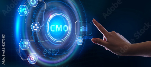 Business, Technology, Internet and network concept. Young businessman working on a virtual screen of the future and sees the inscription: CMO photo