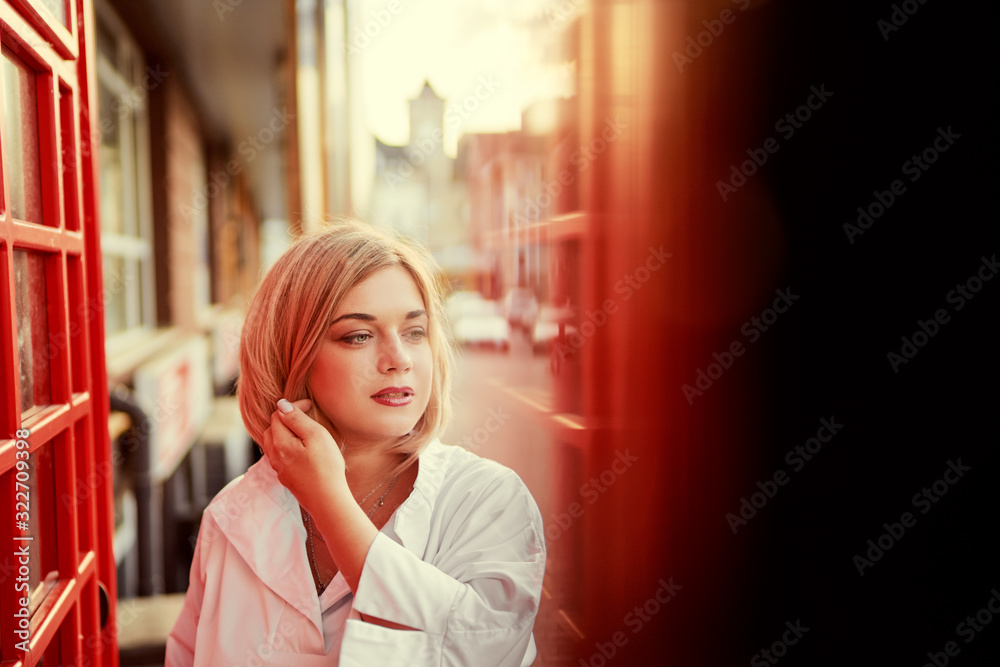 Fototapeta premium Outdoor portrait of happy young woman walking by city street.