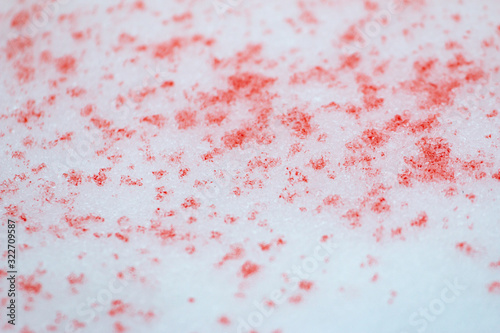 spots of red paint on white snow