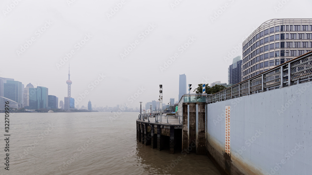 Water level meter in dam with Shanghai city building background in winter, day season of Huangpu river.