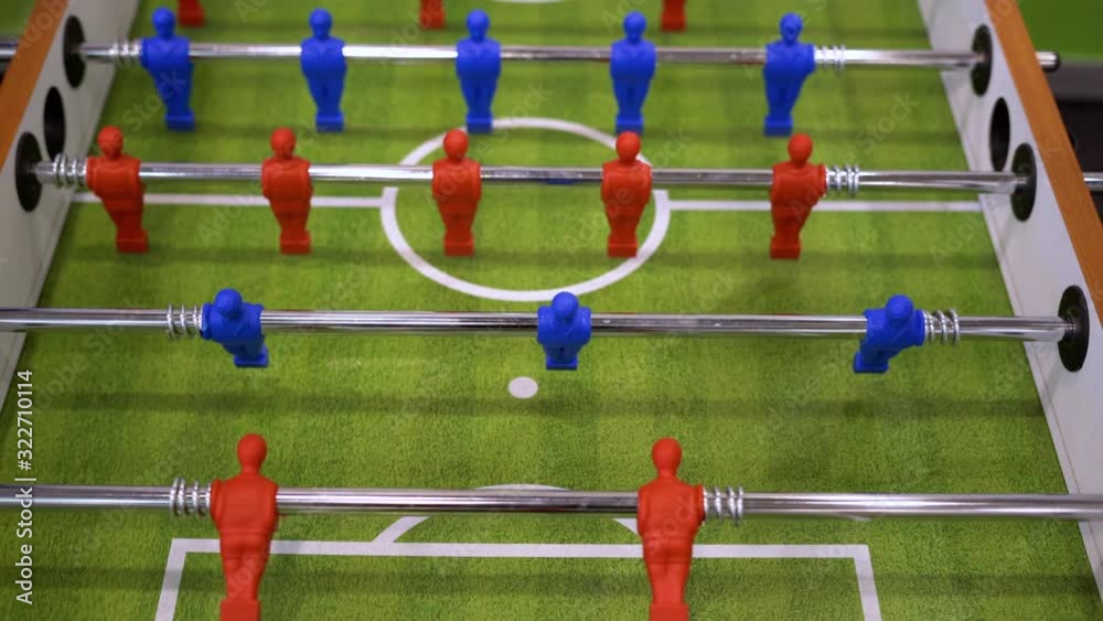 People playing foosball table soccer. Team sport, table football players. Competitive table game People playing foosball table soccer. Team sport, table football players. Competitive table game