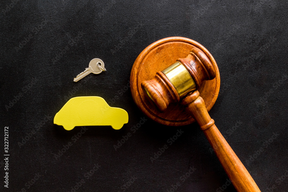 Car credit debt concept with judge gavel on black background top-down Car credit debt concept with judge gavel on black background top-down