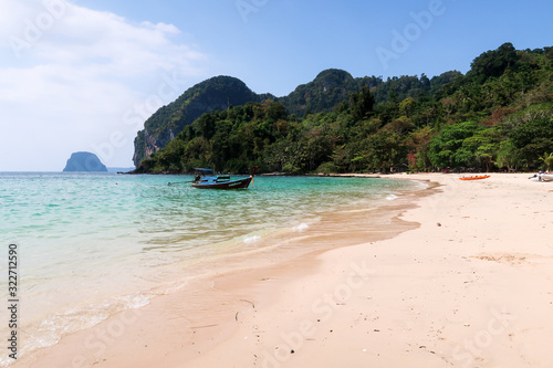 traditional longtailboat on a beach in thailand