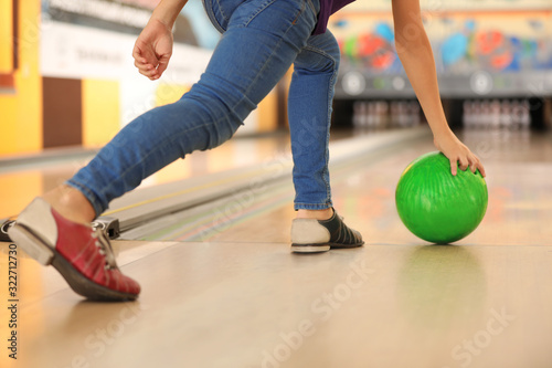 Child throwing ball in bowling club, closeup