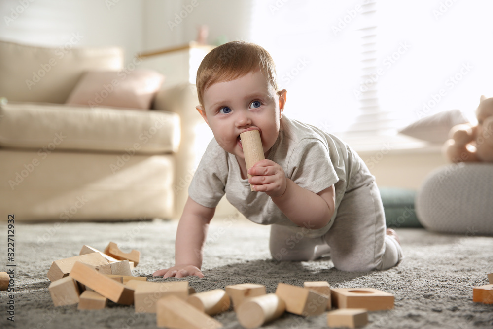 Cute baby playing with wooden blocks at home Cute baby playing with wooden blocks at home