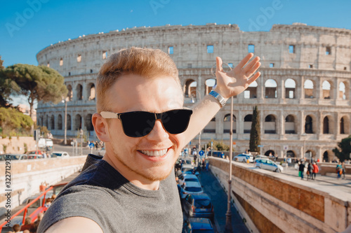 Happy young man making selfie in sunglasses Colosseum in Rome, Italy. Concept travel trip