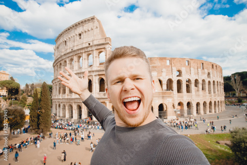 Photography Happy young man making selfie and smile Colosseum in Rome, Italy