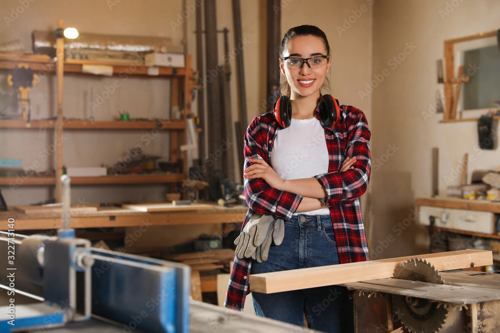 Professional carpenter near sawmill machine in workshop Professional carpenter near sawmill machine in workshop