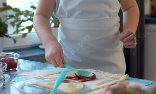 Young chef cooking pizza