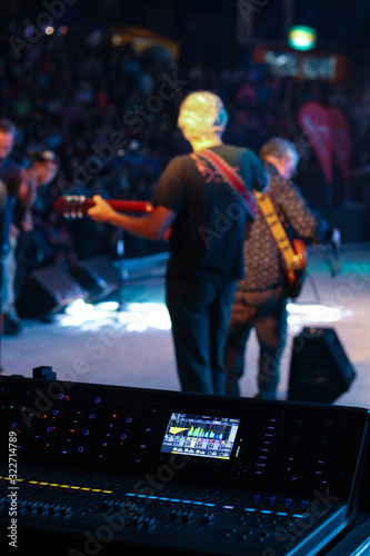 Musicians and console on stage of a concert.