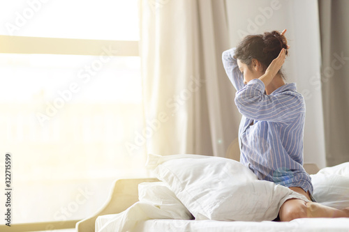 Wallpaper Mural Brunette woman sitting in bed and looking to the window. Young lady White bedsheets and pillow. View from back. Morning in cozy home or hotel apartment. Torontodigital.ca