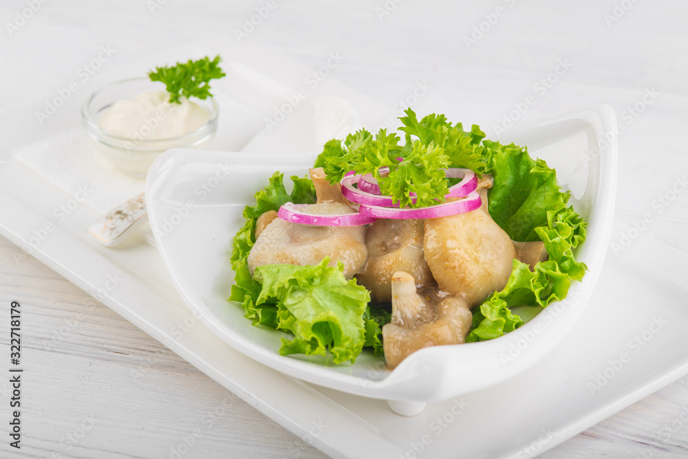 salted mushrooms with onions and sour cream on white wooden background salted mushrooms with onions and sour cream on white wooden background